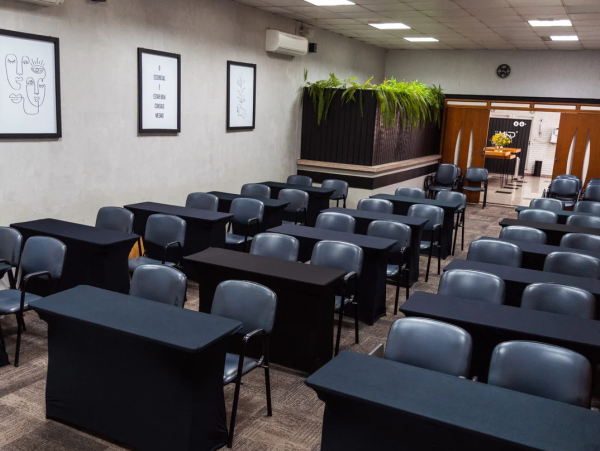 auditorio com mesas e cadeiras organizadas
